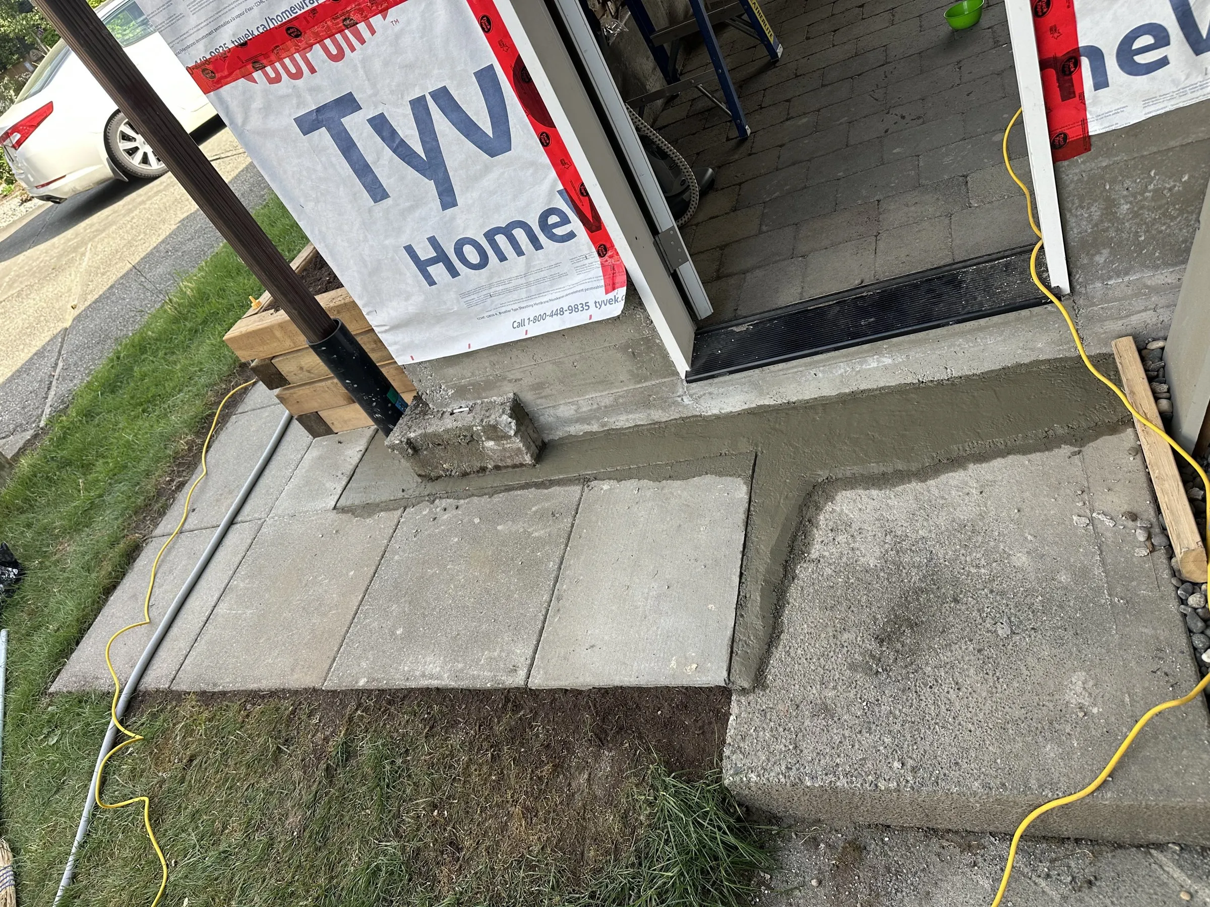 New concrete pad at the side entry